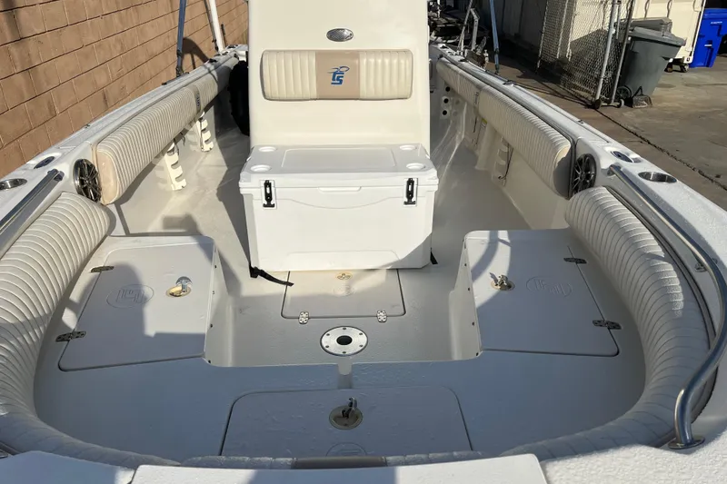 Slide: The Image of 2016 Carolina Skiff 23 Ultra Elite boat interior with seating and storage compartments. - 7