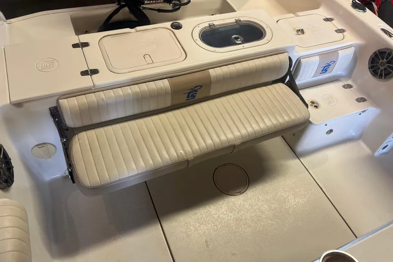 Slide: The Image of 2016 Carolina Skiff 23 Ultra Elite boat interior with seating and storage compartments. - 9