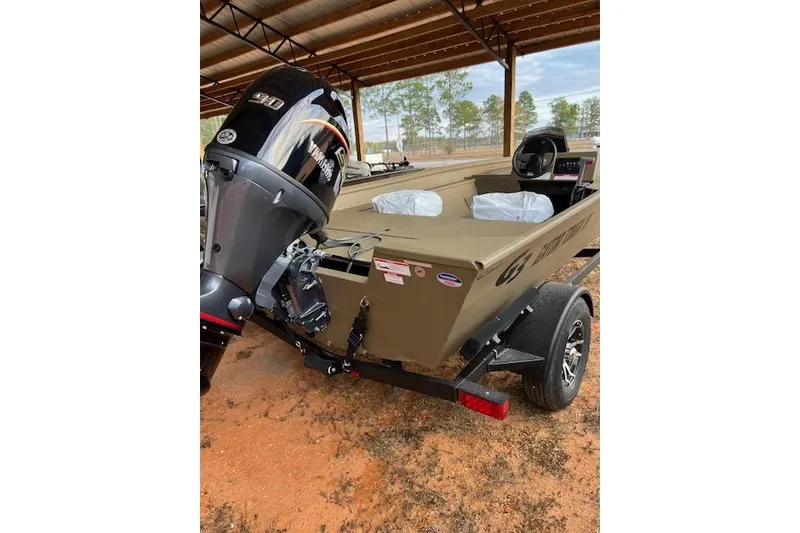 The Image of 2026 G3 Gator Tough 18 SC boat with outboard motor on trailer. - 1