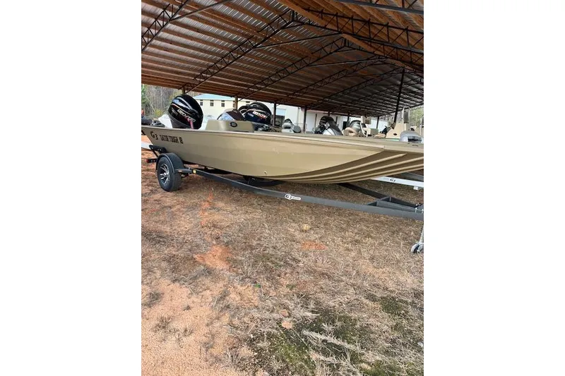 Slide: The Image of 2026 G3 Gator Tough 18 SC boat under a metal canopy on a trailer. - 5