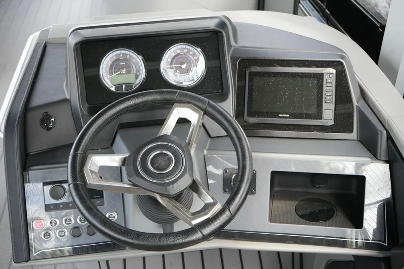 Slide: The Image of Steering console of 2026 Avalon Catalina Cruise Funship, featuring gauges and a Garmin display. - 23