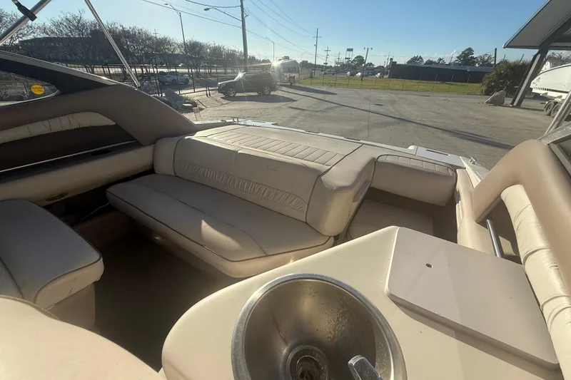 Slide: The Image of 1998 Regal 2250 LSC boat interior with beige seating and a small sink. - 11