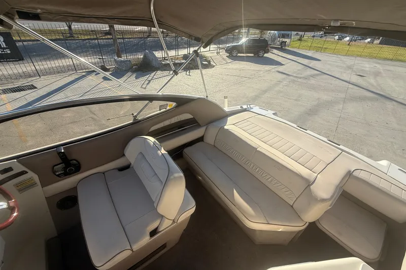 Slide: The Image of Interior of a 1998 Regal 2250 LSC boat with beige seating and canopy. - 12