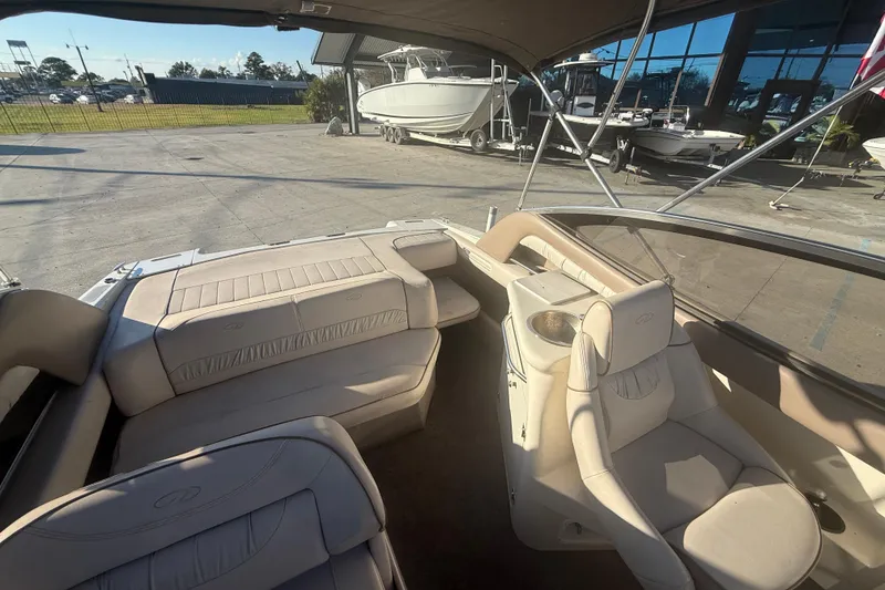 Slide: The Image of Interior of a 1998 Regal 2250 LSC boat with beige seating and open deck view. - 15