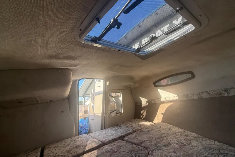 Slide: The Image of Interior cabin of a 1998 Regal 2250 LSC boat with skylight and seating. - 17