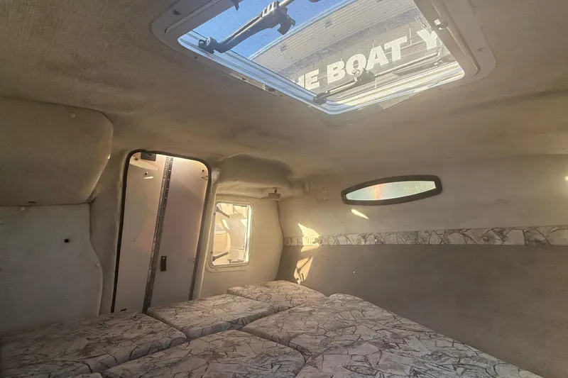 Slide: The Image of Interior cabin of a 1998 Regal 2250 LSC boat with skylight and patterned upholstery. - 18