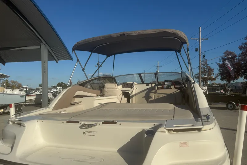 Slide: The Image of 1998 Regal 2250 LSC boat with canopy, parked outdoors under clear blue sky. - 4