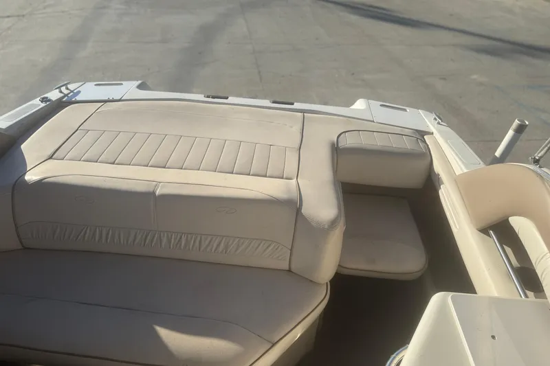 Slide: The Image of 1998 Regal 2250 LSC boat interior with beige seating and sunlit deck. - 6