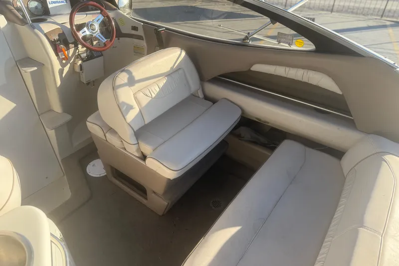 Slide: The Image of 1998 Regal 2250 LSC boat interior with beige seating and steering wheel. - 7
