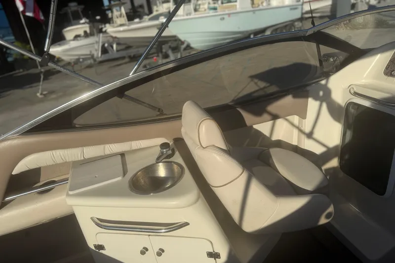 Slide: The Image of 1998 Regal 2250 LSC boat interior with beige seating and a small sink. - 8