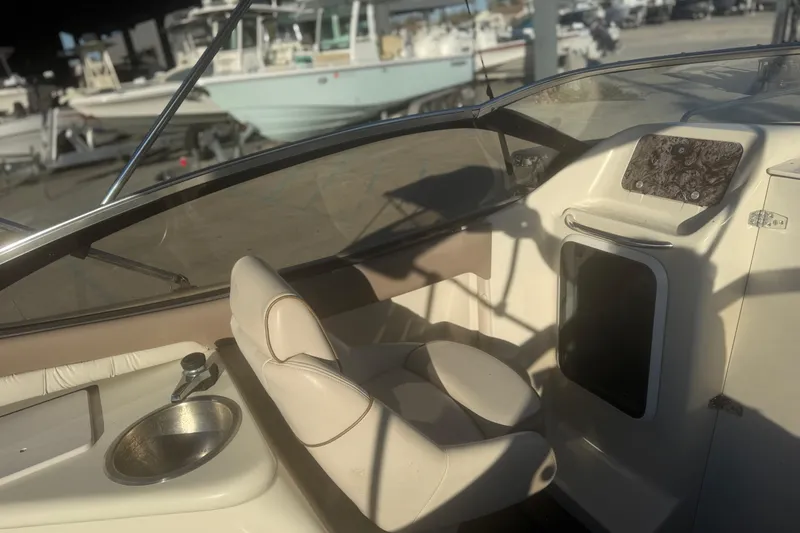 Slide: The Image of 1998 Regal 2250 LSC boat interior with steering wheel and seating area. - 9
