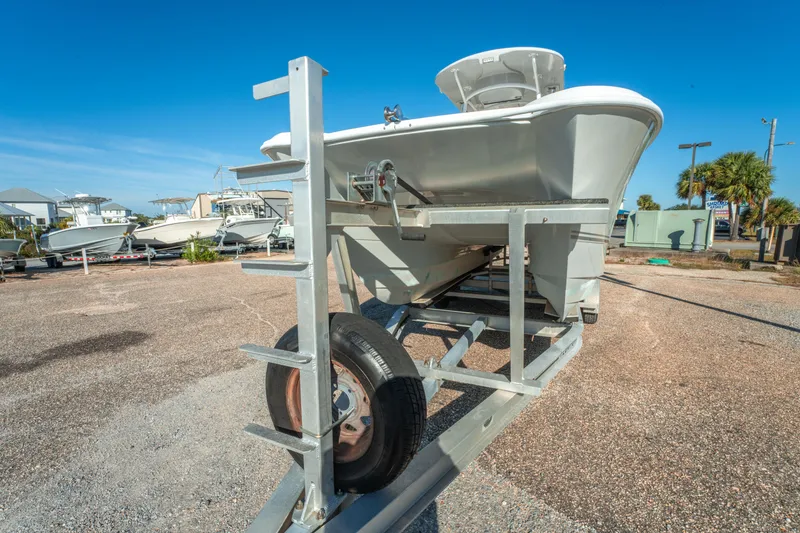 Slide: The Image of 2020 Twin Vee 240 GFX CC boat on trailer in sunny outdoor setting. - 11