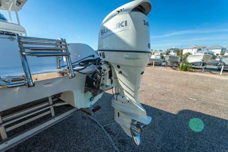 Slide: The Image of 2020 Twin Vee 240 GFX CC boat with Suzuki outboard motor in a marina. - 13