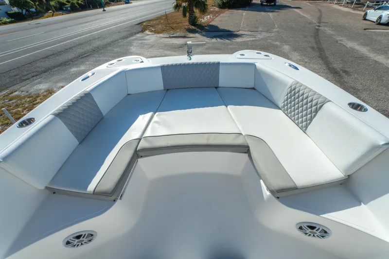 Slide: The Image of 2020 Twin Vee 240 GFX CC boat interior with white cushioned seating and cup holders. - 17