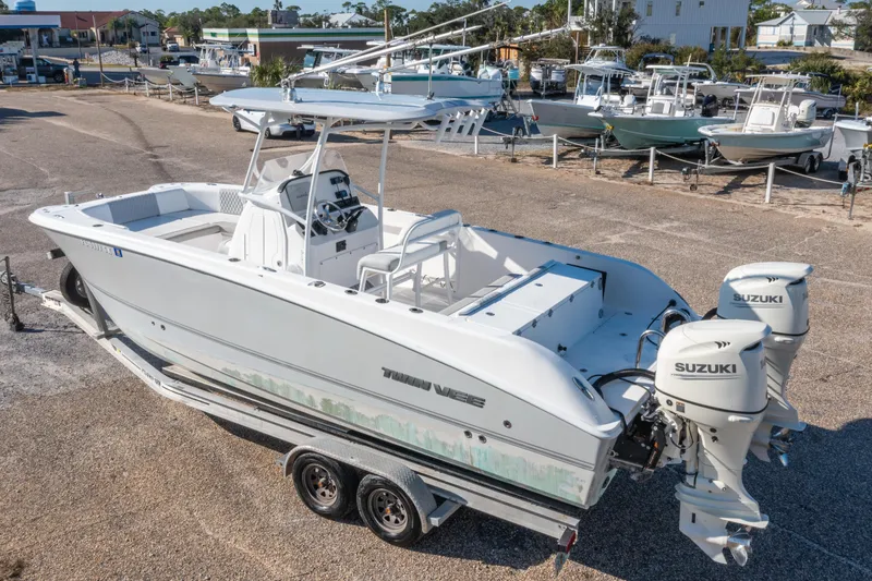 Slide: The Image of 2020 Twin Vee 240 GFX CC boat with dual Suzuki engines on a trailer. - 2