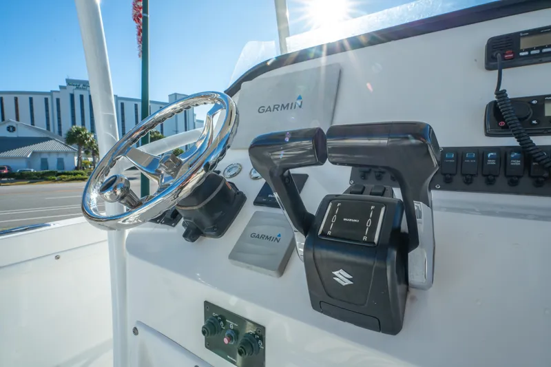 Slide: The Image of 2020 Twin Vee 240 GFX CC boat dashboard with Garmin controls and steering wheel. - 20