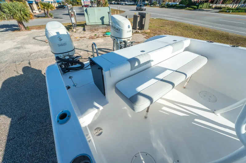 Slide: The Image of 2020 Twin Vee 240 GFX CC boat with Suzuki 140 engines, white seating, and outdoor setting. - 22