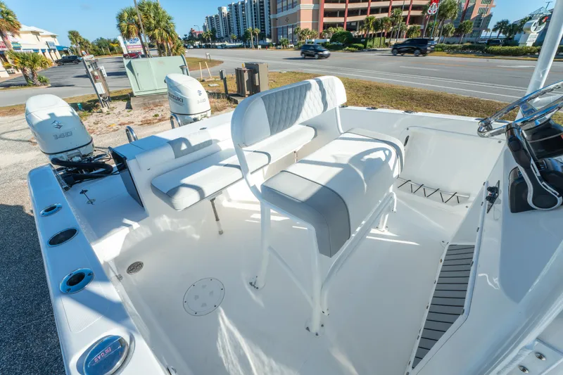 Slide: The Image of 2020 Twin Vee 240 GFX CC boat interior with seating and dual Suzuki 140 engines. - 23
