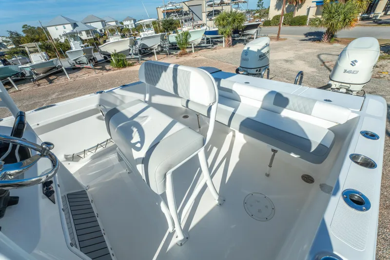 Slide: The Image of 2020 Twin Vee 240 GFX CC boat interior with seating and dual Suzuki 140 engines. - 24