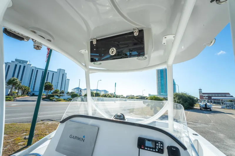 Slide: The Image of 2020 Twin Vee 240 GFX CC boat dashboard with Garmin equipment, cityscape in background. - 27