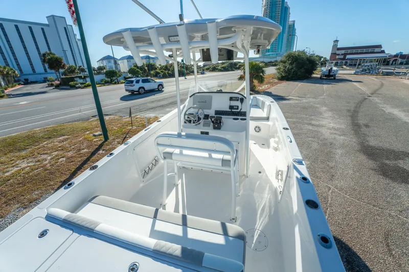 Slide: The Image of 2020 Twin Vee 240 GFX CC boat parked near a road with buildings in the background. - 29