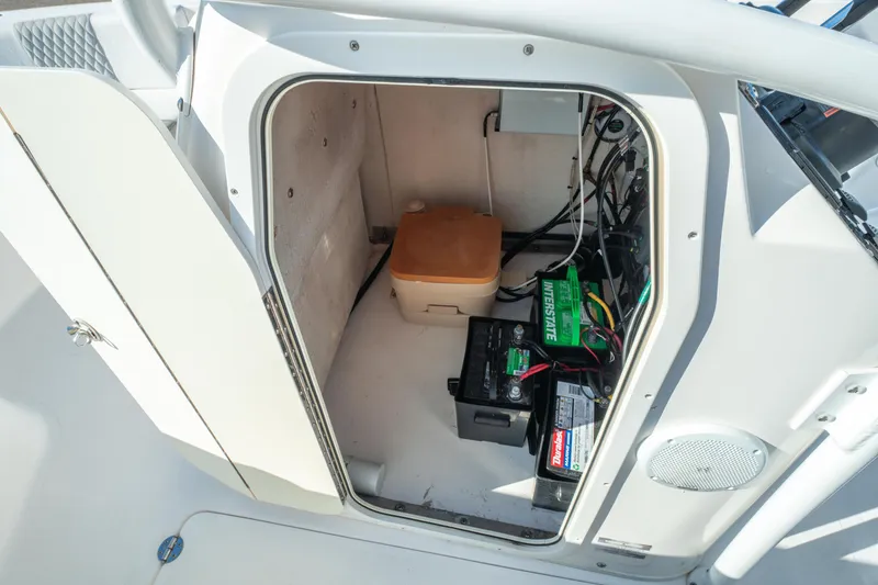 Slide: The Image of 2020 Twin Vee 240 GFX CC boat storage compartment with batteries and equipment. - 40