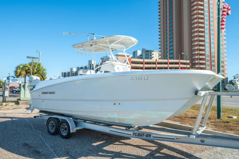Slide: The Image of 2020 Twin Vee 240 GFX CC boat on trailer, urban background, clear sky. - 5