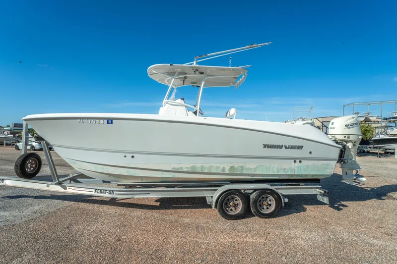 Slide: The Image of 2020 Twin Vee 240 GFX CC boat on trailer under clear blue sky. - 9