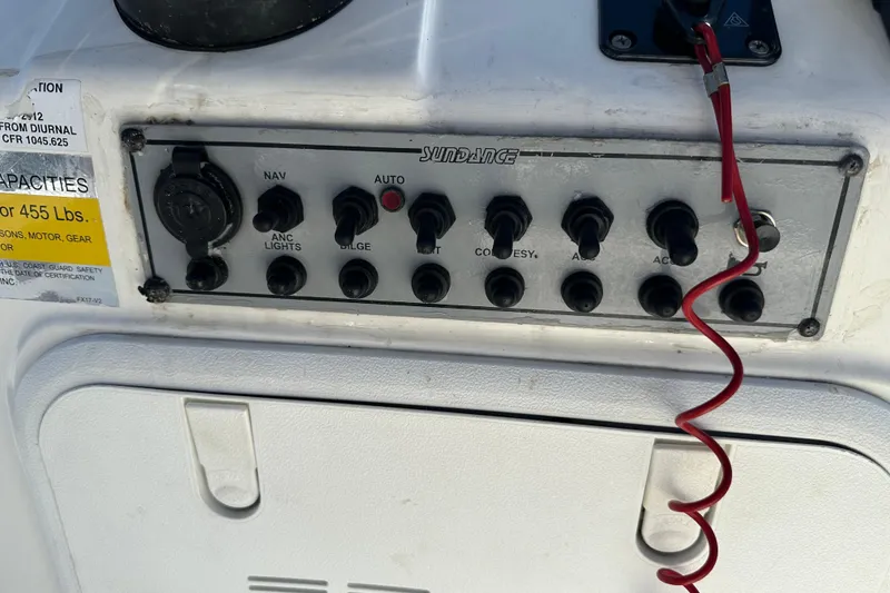 Slide: The Image of Control panel of a 2013 Spyder FX17 Flicker boat with various switches and labels. - 19