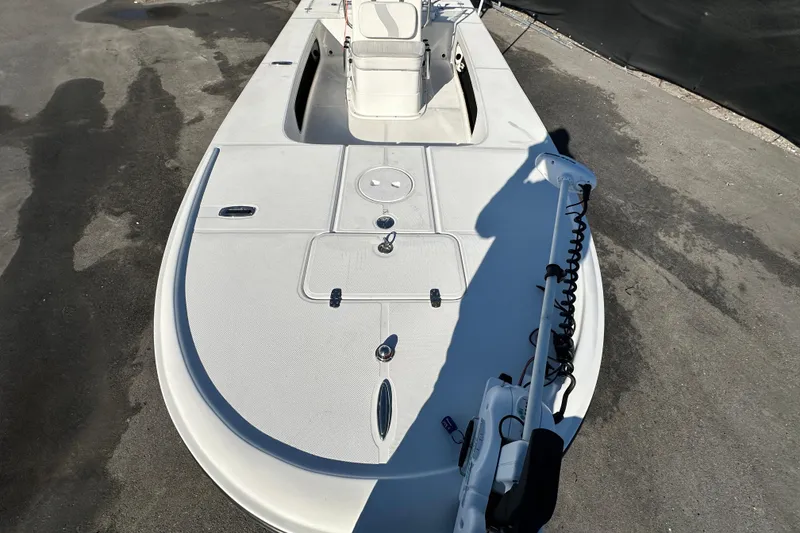 Slide: The Image of 2013 Spyder FX17 Flicker boat deck with trolling motor, parked on pavement. - 26