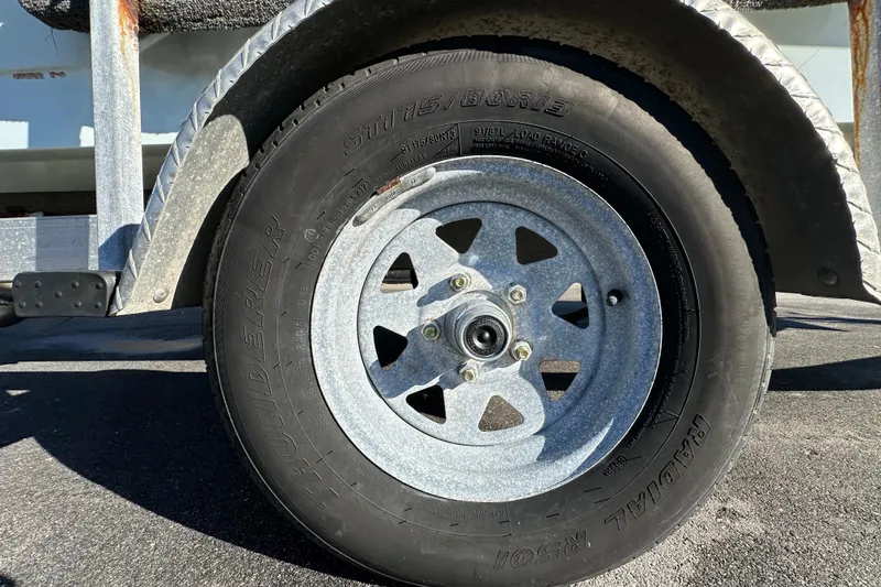 Slide: The Image of Trailer wheel of a 2013 Spyder FX17 Flicker, featuring a Thunderer radial tire. - 36