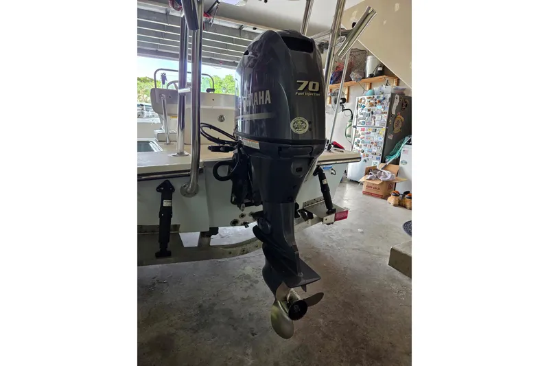 Slide: The Image of 2013 Spyder FX17 Flicker boat on trailer at a dealership under clear blue sky. - 4