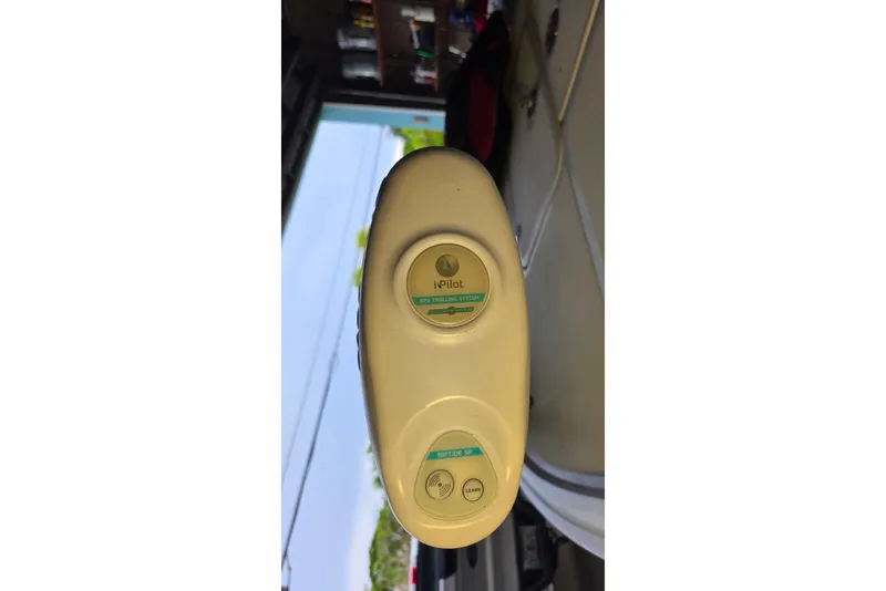 Slide: The Image of 2013 Spyder FX17 Flicker boat on trailer at dealership under clear blue sky. - 5