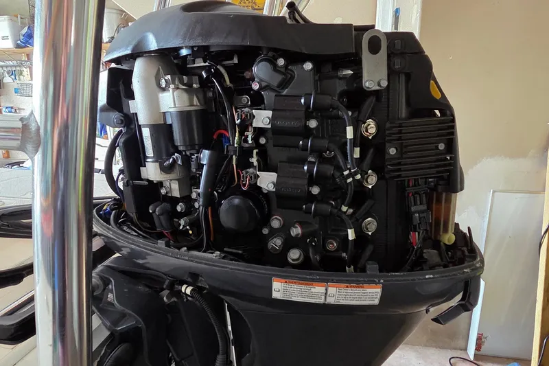 Slide: The Image of 2013 Spyder FX17 Flicker boat with 70HP fuel injection engine, parked outdoors. - 8