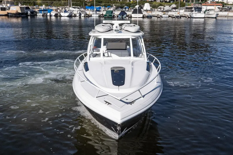 Slide: The Image of 2016 Intrepid 400 Cuddy boat docked in a marina, front view. - 15