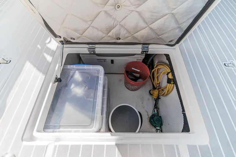 Slide: The Image of Storage compartment on 2016 Intrepid 400 Cuddy boat with tools and equipment. - 25