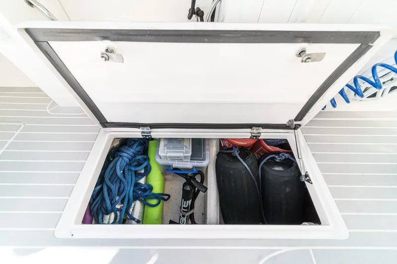 Slide: The Image of Storage compartment on a 2016 Intrepid 400 Cuddy boat with ropes and equipment. - 28