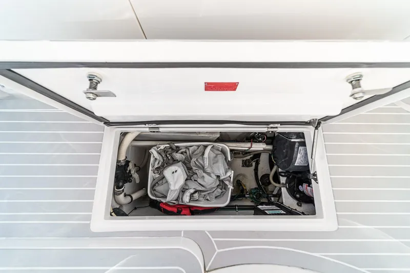 Slide: The Image of Storage compartment of a 2016 Intrepid 400 Cuddy boat, showing equipment and gear. - 29