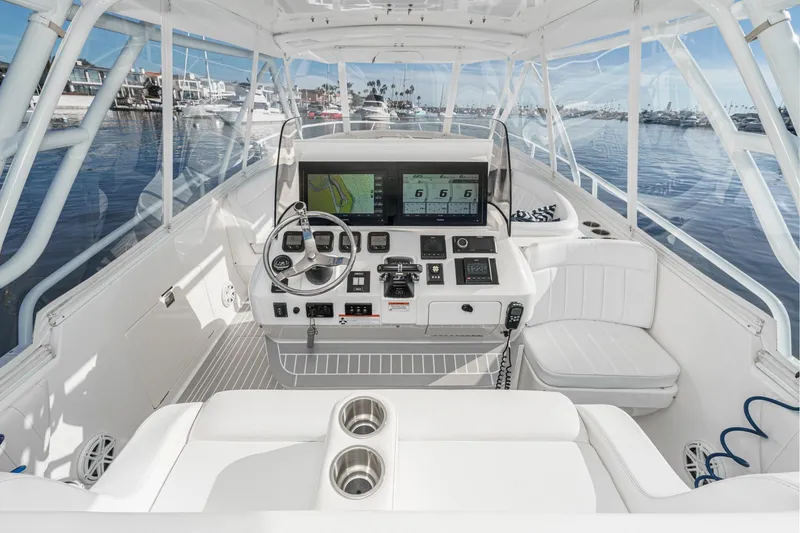 Slide: The Image of 2016 Intrepid 400 Cuddy boat cockpit with modern navigation equipment and luxurious seating. - 34