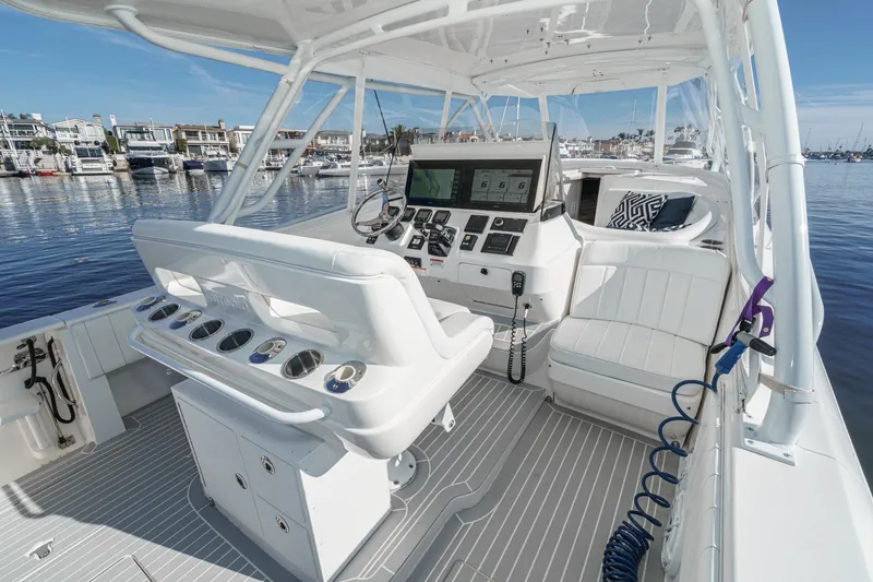 Slide: The Image of 2016 Intrepid 400 Cuddy boat interior with modern helm, docked in marina. - 41