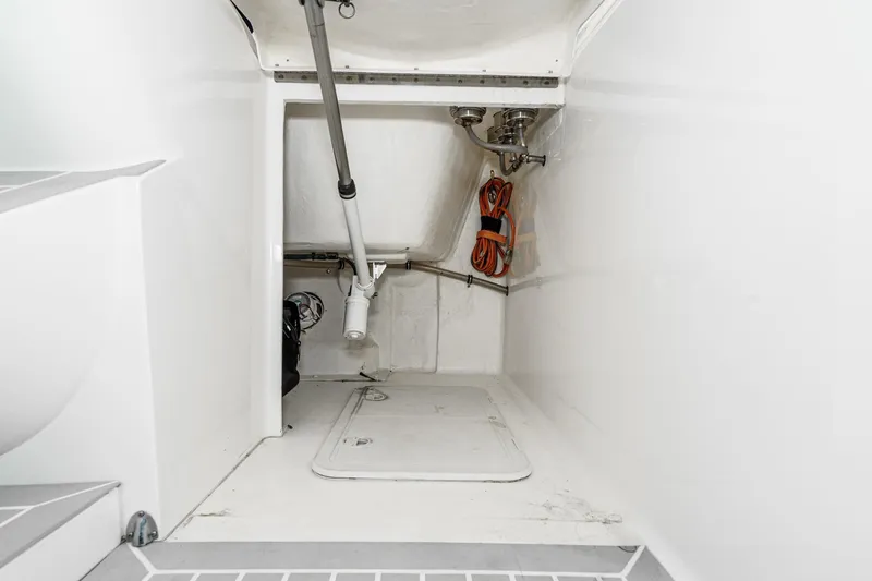 Slide: The Image of 2016 Intrepid 400 Cuddy storage compartment with equipment and wiring. - 42