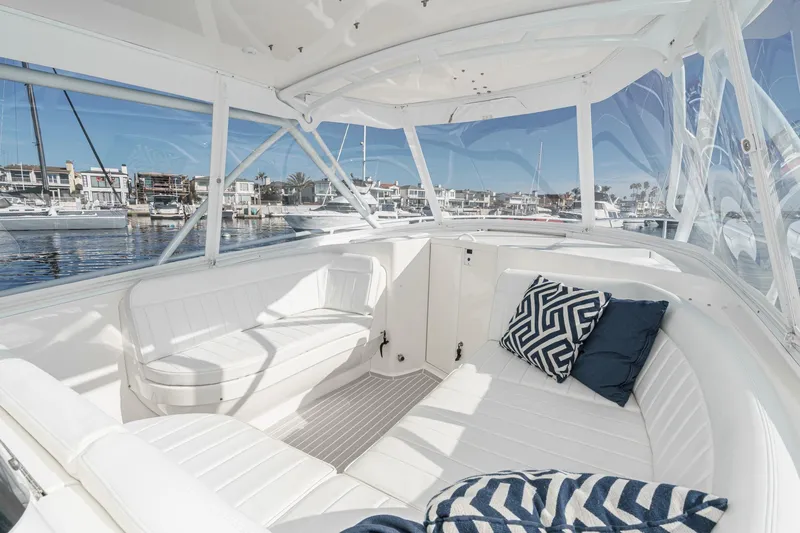 Slide: The Image of 2016 Intrepid 400 Cuddy boat interior with white seating and decorative pillows. - 45