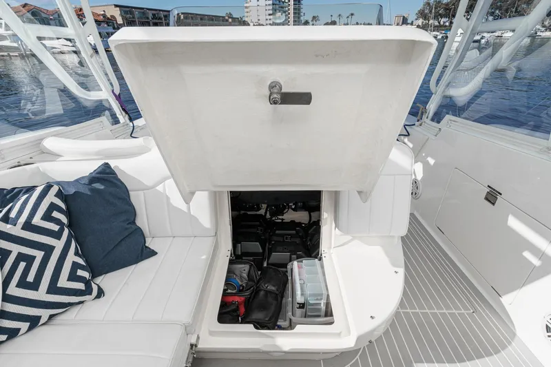 Slide: The Image of 2016 Intrepid 400 Cuddy boat interior with open storage compartment and cushions. - 48