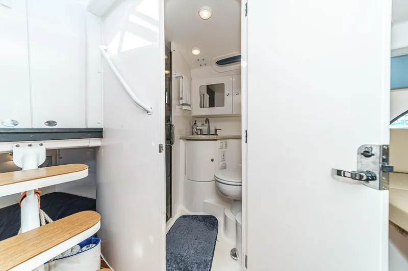 Slide: The Image of Interior of 2016 Intrepid 400 Cuddy boat featuring a compact bathroom. - 57