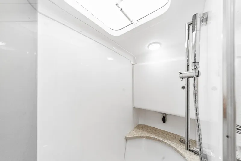 Slide: The Image of Interior of 2016 Intrepid 400 Cuddy boat bathroom with shower and skylight. - 59