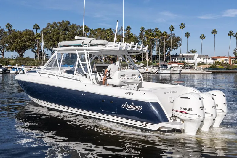 Slide: The Image of 2016 Intrepid 400 Cuddy boat with Yamaha engines cruising in a marina. - 6