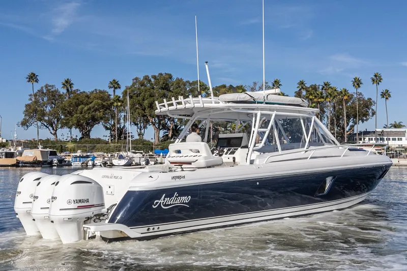 Slide: The Image of 2016 Intrepid 400 Cuddy boat with Yamaha engines in a marina setting. - 7