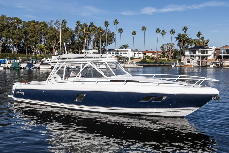 Slide: The Image of 2016 Intrepid 400 Cuddy boat on calm water with palm trees in the background. - 9