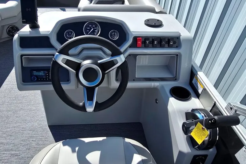 Slide: The Image of 2026 Godfrey Experience 2086 BFX boat dashboard with steering wheel and controls. - 11