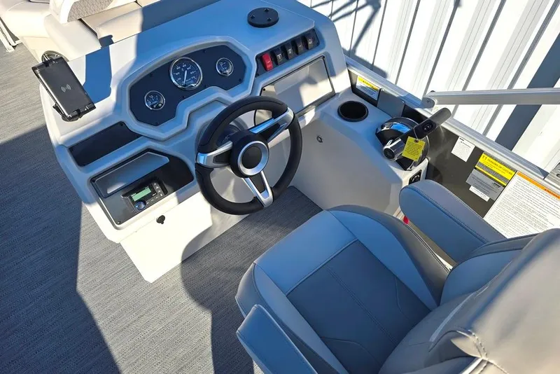 Slide: The Image of 2026 Godfrey Experience 2086 BFX boat helm with steering wheel and controls. - 2